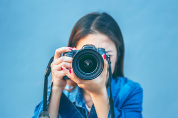 Photographer taking pictures with digital camera. Vintage tone.