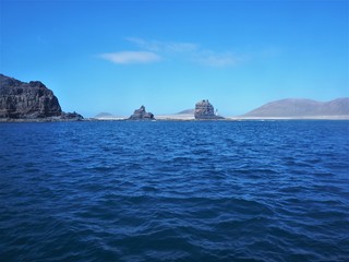 Rocks on a spit of land on Lanzarote, with a view of La Graciosa island