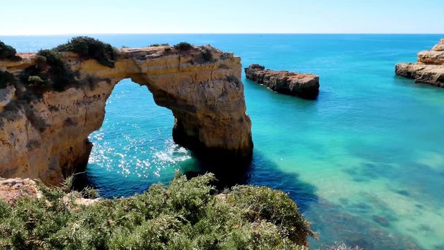 natural arch and turquoise sea on a sunny day, beach Praia da Albandeira, Algarve