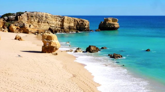 sunny day at beach Praia Sao Rafael, Algarve, Portugal