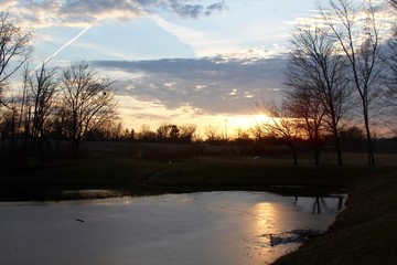 The sunset over the lake in the countryside.
