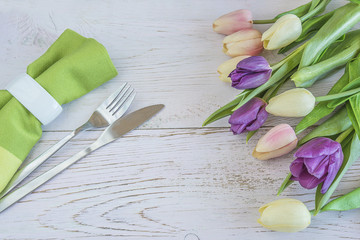 Festive table setting with bouquet of fresh tulips
