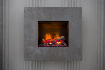 Modern grey fireplace in a retro home, burning fire cozy and warm