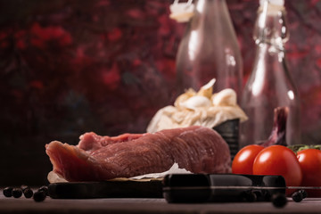 Detail of pork tenderloin and other ingredients on vintage board
