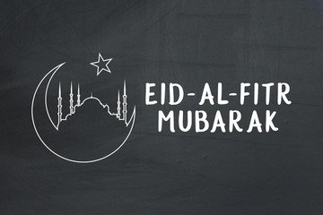 Welcoming ramadan. Eid-Al-Fitr mubarak text on chalkboard.