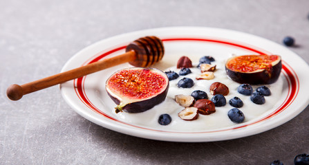 Yogurt with berries fresh figs, blueberries and honey.Food or Healthy diet concept.Super Food.selective focus.