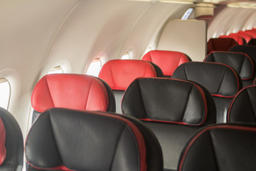 on board empty black with red passenger airplane seats