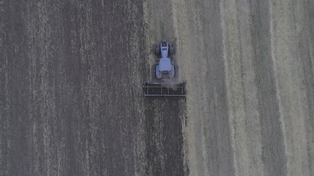 The combine removes the mote that has remained after mowing. A beautiful pattern on the ground after cutting the glass. View from above. Aerial view. 4k Video