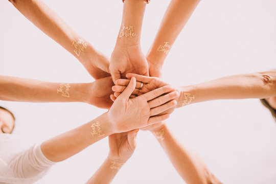 Hands of cheering people in circle