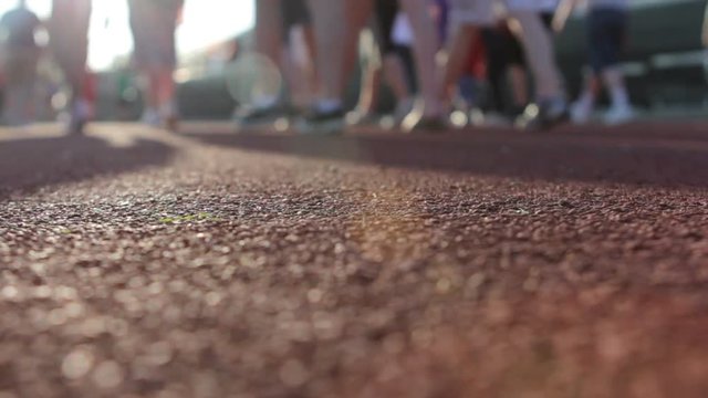 People Walking Around Track In A Relay For Life Fundraiser.
