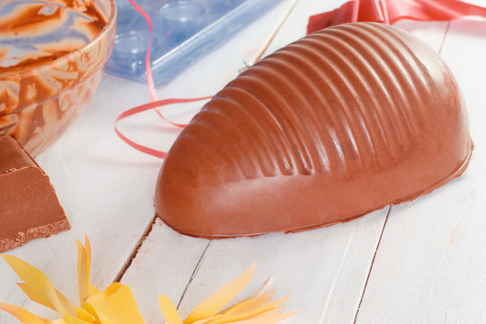 Chocolate Easter Egg Making Process, Showing A Chocolate Egg Half, And Piece, Cast And Molds, With Decorative Ribbons