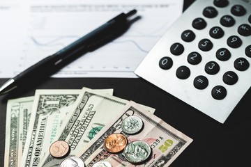 Closeup of a Calculator with Financial Figures and Money