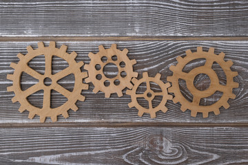 Gear wheels on a wooden background. The concept of creative, logical thinking. Logic background. gears of natural wood. strategy, business idea, teamwork