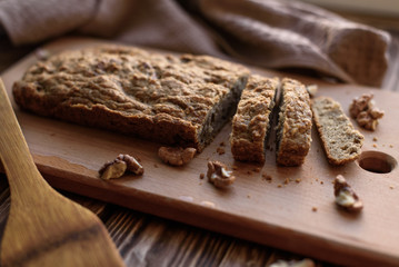 Homemade baking bread with nuts, low key lighting, rustic style.