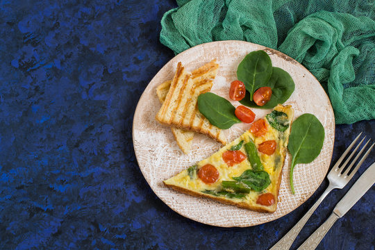 Frittata with asparagus, cherry tomatoes and spinach