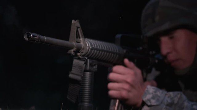 Young military soldier shooting gun