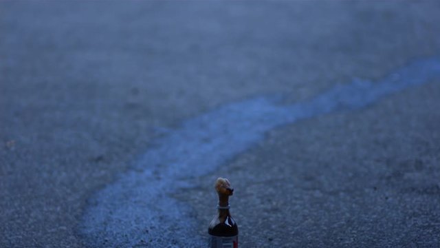 Ultra Slow Motion footage of a bottle of cola erupting in a foamy tower