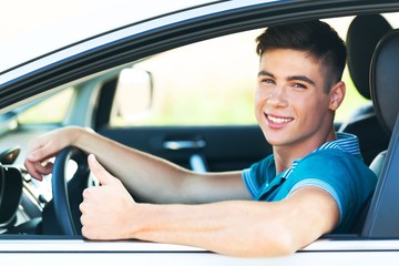Portrait of Young Man in his Car Showing Thumbs Up