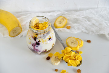 Breakfast in a jar: cereal, banana, berries, granola. The concept of healthy eating, high-carbon Breakfast.