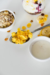 Breakfast in a jar: cereal, banana, fresh berries, granola, yogurt on a light background. The concept of healthy eating, high-carbon Breakfast.