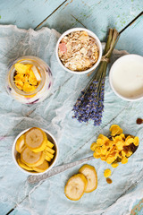 Breakfast in a glass jar: homemade granola, banana, fresh berries, yogurt on a light textile background with a bouquet of lavender. The concept of healthy eating, high-carbon Breakfast.