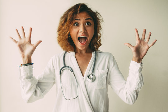 Portrait Of Scared Or Excited Young Female Doctor