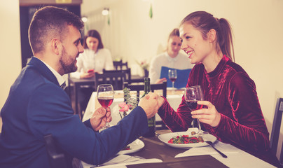 Elegant female and her boyfriend are celebrating date for dinner