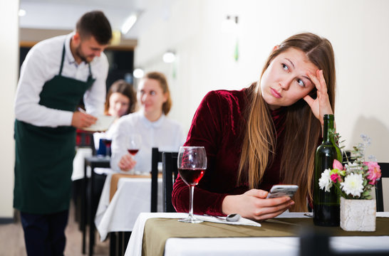 Sad woman is dining in luxury restaurante alone