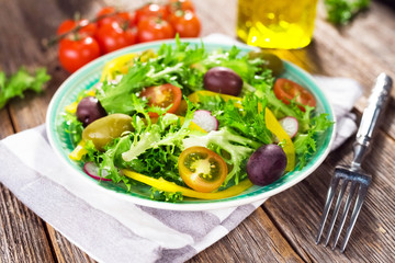Fresh mixed salad on wooden backgeound