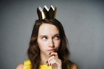 woman in yellow dress looking up thoughtfully