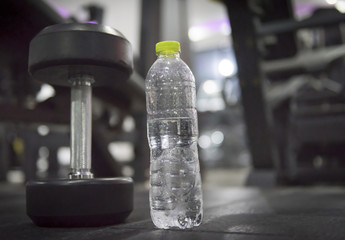 water and dumbbells in the fitness.