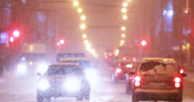 City Traffic In Winter Snowy Snowstorm Evening Or Night Time