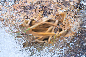 Openwork crystal ice on the spring thawed.