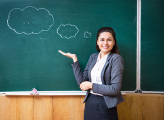 a young teacher shows an idea near the board