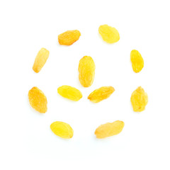 Top view of a circle of gold raisins on a white background. Circle with a symbol inside. Dried yellow grapes.