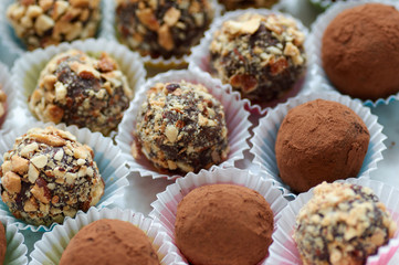 Delicious Chocolate Truffles with Rum and Nuts.Close up of colorful healthy homemade candies with nuts,selective focus.Set of different kinds of delicious dessert/Assorted Chocolate truffles