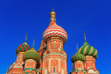Fototapeta na wymiar Domes of St. Basil's Cathedral on a blue sky background. Moscow in winter