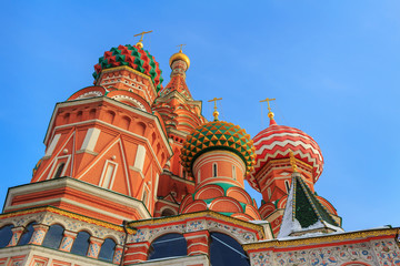 Fototapeta na wymiar Domes of St. Basil's Cathedral against the blue sky. Moscow in winter