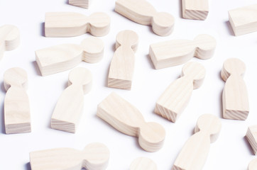 Wooden figures of people on a white background. The concept of society, collective, company, family, neighbors. A crowd of people at a meeting, rally. Workers, employees, citizens. Kids toys. Close up