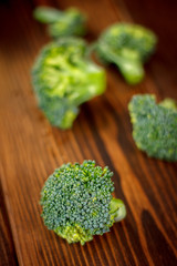 Beautiful broccoli crowns on wooden board.