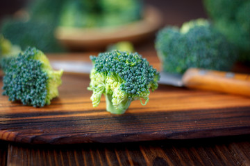 Fresh broccoli florets staying on the kitchen board like a tree.