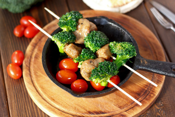 Vegetarian kebabs with seitan and broccoli on a skewers.