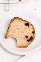 Slice of traditional German or Austrian Gugelhupf or Kouglof from Alsace, France, a round bundt cake with raisins made of brioche yeast sponge or sweet bread dough and dusted with sugar
