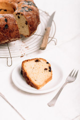 Slice of traditional German or Austrian Gugelhupf or Kouglof from Alsace, France, a round bundt cake with raisins made of brioche yeast sponge or sweet bread dough and dusted with sugar