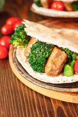 Fototapeta na wymiar Vegetarian seitan with vegetables inside pita bread.