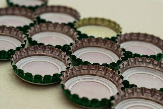 Close up image of caps from beer bottles and other beverages