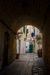Fototapeta premium Vertical View of a Coloured Alley in the Historic Centre in San Paolo District. Bari, South of Italy
