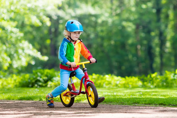 Kids ride balance bike in park