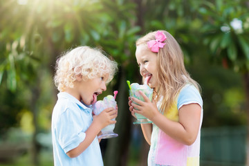 Kids eating ice cream. Child with fruit dessert.
