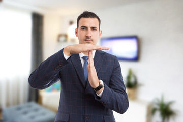 Real estate agent realtor making time for break pause gesture.